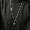 Louis Vuitton Vivienne pendant in polished metal with LV lettering