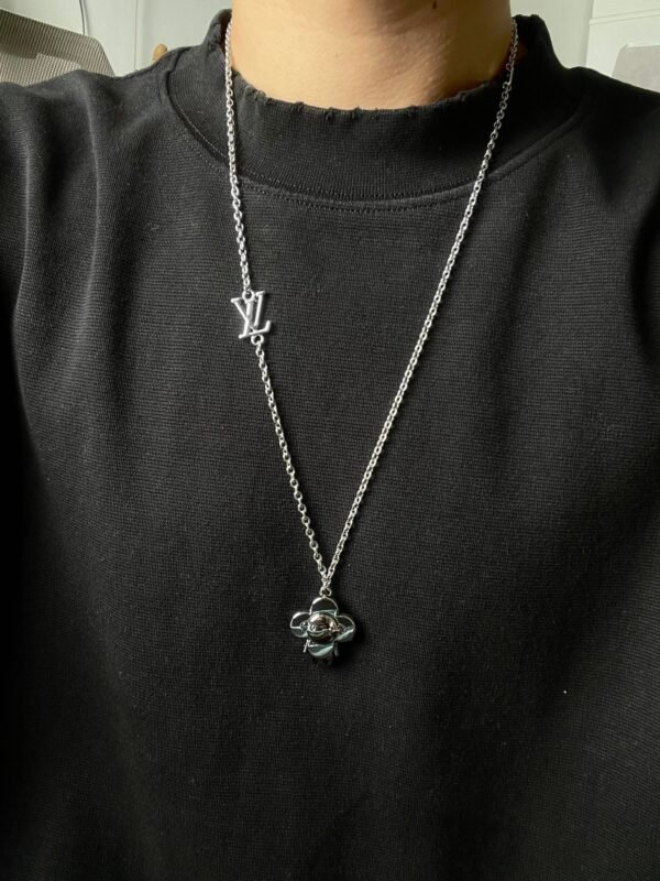 Louis Vuitton Vivienne pendant in polished metal with LV lettering