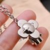 Louis Vuitton Vivienne pendant in polished metal with LV lettering