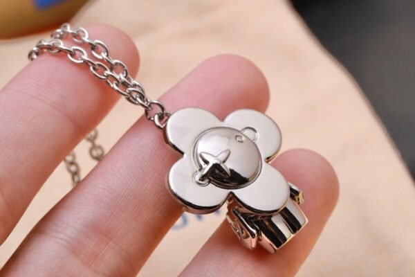 Louis Vuitton Vivienne pendant in polished metal with LV lettering