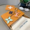 Louis Vuitton keychain bag pendant One of the hallmarks of the Fleur de Monogram bag