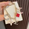 Louis Vuitton keychain bag pendant One of the hallmarks of the Fleur de Monogram bag