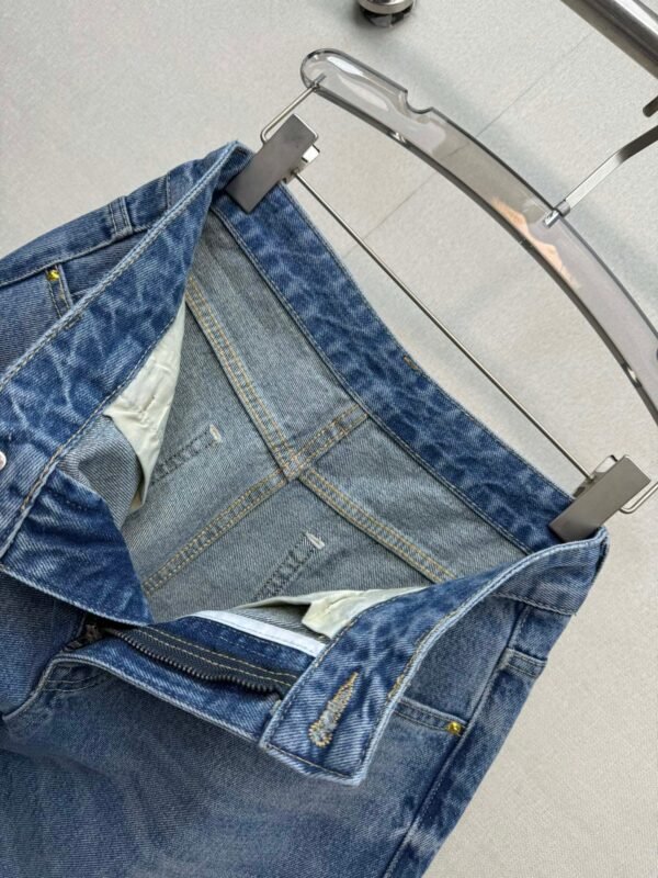 Miu Miu style jeans with rhinestone embellishments on the cuffs, made with high-quality fabric and a special washing process.