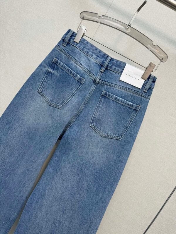 Miu Miu style jeans with rhinestone embellishments on the cuffs, made with high-quality fabric and a special washing process.