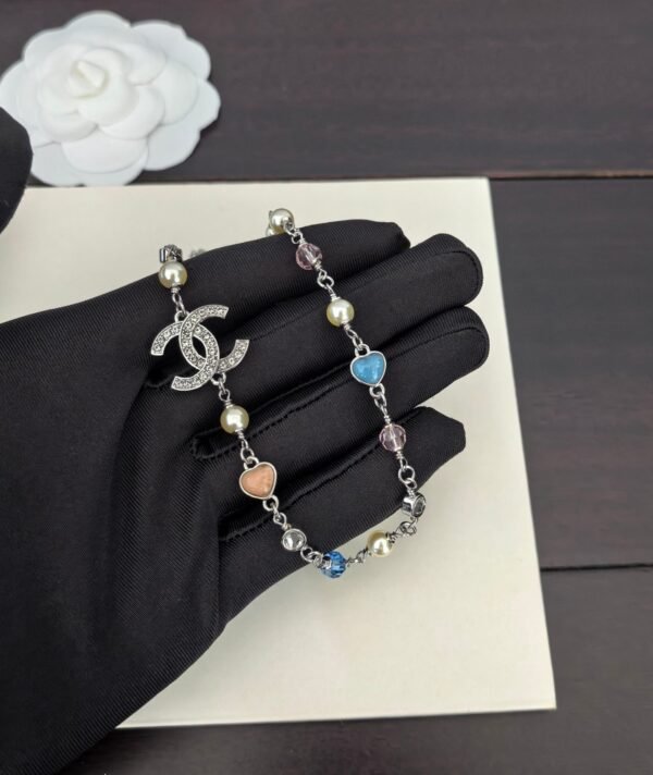 A white gold, blue and pink heart-shaped necklace