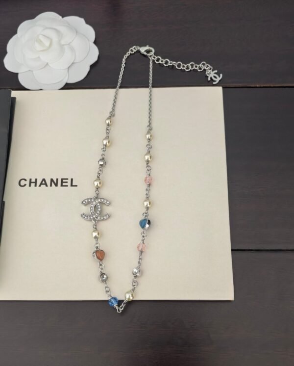A white gold, blue and pink heart-shaped necklace