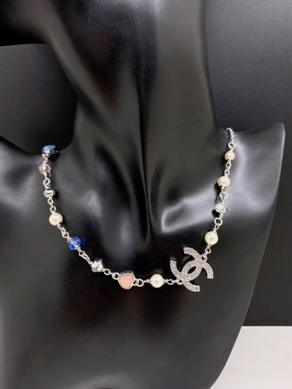 A white gold, blue and pink heart-shaped necklace