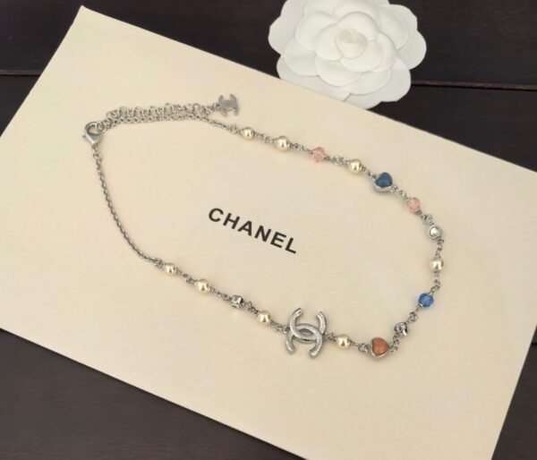 A white gold, blue and pink heart-shaped necklace